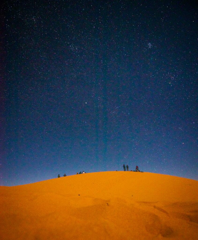 people at the desert at night time